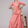 A Peach Color Printed Silk Blend Peplum Top And Skirt With Net Dupatta